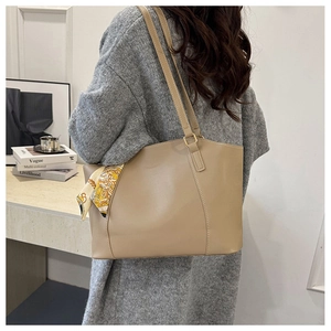 Large khaki leather tote bag for women with stylish scarf detail shown on shoulder