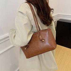 Brown retro leather tote bag with knotted straps and gold hardware for daily commuting