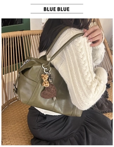 Olive green tote bag detail with leopard heart pendant and side zipper pocket
