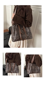 Detail shot of leopard print tote bag featuring dual handles and wide fabric strap