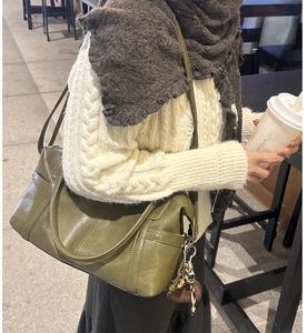 Olive green vintage shoulder bag with visible stitching and silver metal hardware details