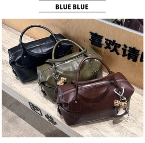 Three retro leather Boston bags in black, olive green, and reddish-brown with leopard bows