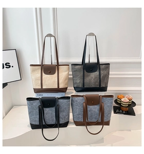 Detail view of canvas and leather tote bags in four colors with a textured finish