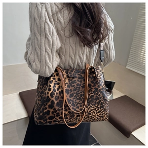 Detail of large leopard print tote bag in leather with stylish straps for autumn style