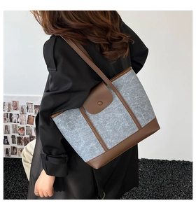 Fashionable felt tote bag with leather trim shown on a model for daily commute styling