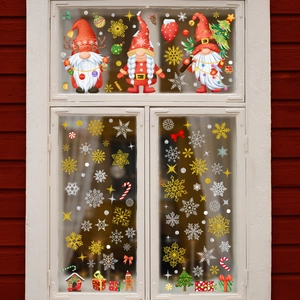 Christmas gnome window clings with snowflakes and pine trees on a glass window pane