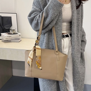 Chic beige faux leather tote bag with elegant silk scarf and long shoulder straps