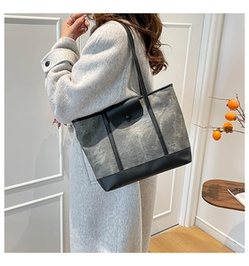 Retro grey and black leather patchwork tote bag styled on a model's shoulder