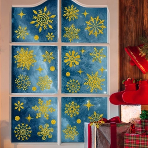 Detailed view of gold glitter snowflake window stickers on frosted glass for Christmas decor