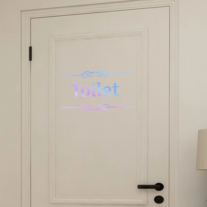 Close-up of holographic laser Toilet door sticker with elegant scroll pattern
