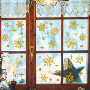 Macro detail of golden snowflake window decals with glitter texture for Christmas decor
