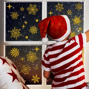 Detailed view of golden glitter snowflake window stickers and stars for Christmas decor