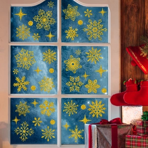Golden glitter snowflake window clings set for Christmas glass decoration on blue background