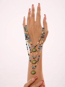 Detailed close-up of layered bohemian beaded necklaces with colorful Evil Eye pendants
