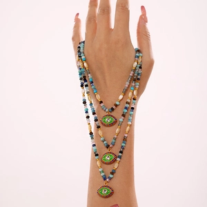 Three-layer beaded necklace with colorful stones and green enamel evil eye pendants