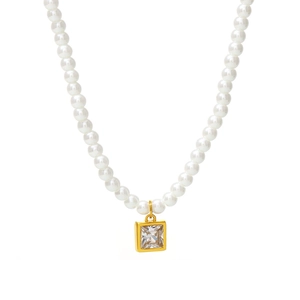 Elegante collana di perle dorate con pendente geometrico in zirconia su sfondo bianco