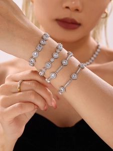 Macro view of silver color bracelets set with pear, square, round and heart cubic zirconia
