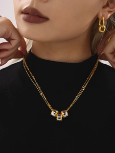 Detailed close-up of multilayer stainless steel necklace with colorful beads on a model