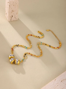 Detail of multi-layer beaded necklace with gold tone chains and LOVE cylinder pendants