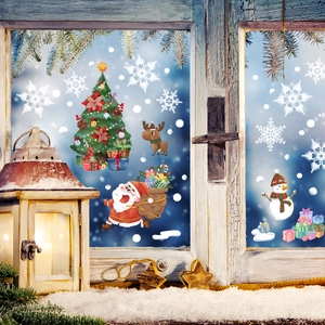 Close-up of Santa Claus and Reindeer static window decals on a festive snowy glass pane