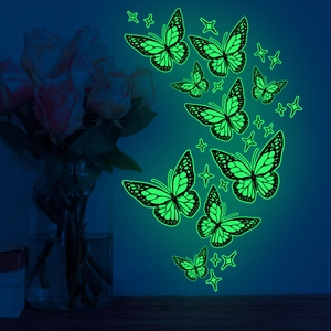 Luminous green butterfly and star wall decals glowing in dark bedroom decor