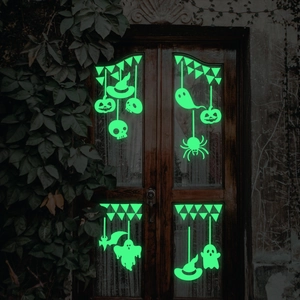 Luminous Halloween window stickers with ghosts and pumpkins on a glass door