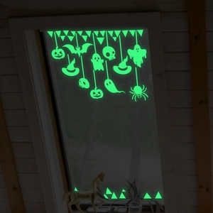 Luminous Halloween window stickers featuring glowing pumpkins, ghosts, and bats in the dark