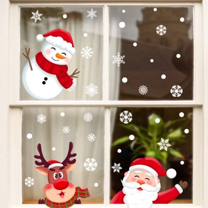 Christmas window decals with Santa Claus, reindeer, and snowflakes on glass pane