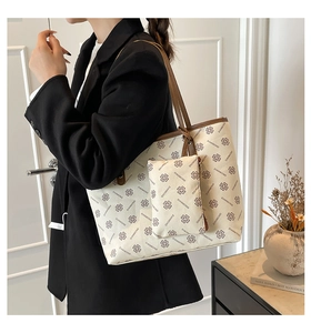 Detail of cream tote bag with clover pattern and matching small zipper pouch set