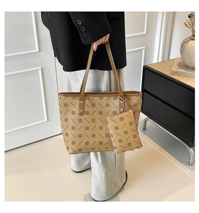 Detail shot of large khaki tote bag set with clover pattern and matching mini pouch