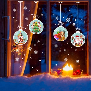 Detail of Christmas window clings with Santa and Reindeer inside festive snow globes