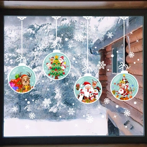 Macro view of Christmas window decals featuring festive Santa and reindeer ornaments