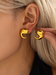 Close-up of polished 18K gold-plated teardrop earrings shown on a female model