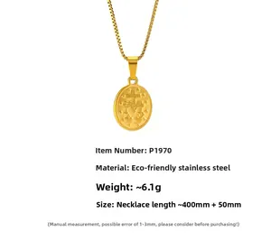 Detail of gold oval religious pendant with embossed cross on a square link chain