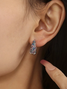 Close-up of 18K gold-plated hoop earrings with colorful turquoise and zircon on model