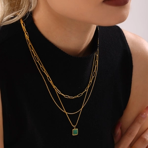 Three-layer gold necklace with paperclip chain, bead chain, and green malachite square pendant