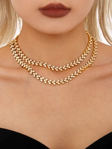 Close-up of double-layer 18K gold-plated stainless steel necklace with sparkling zircons