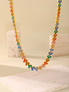 Detail of multi-color zircon stones and gold-plated chain links on a luxury necklace