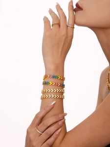 Close-up of luxury 18K gold-plated bracelets featuring multi-color heart-shaped cubic zirconia