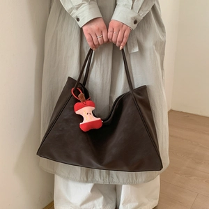 Deep brown large tote bag in PU leather with a red apple core plush charm accessory