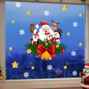 Detail of Christmas window stickers with Santa, reindeer, and snowflakes on a glass pane