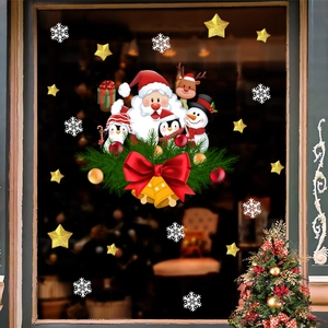 Detail of Christmas window clings showing Santa, reindeer, and snowflakes on glass