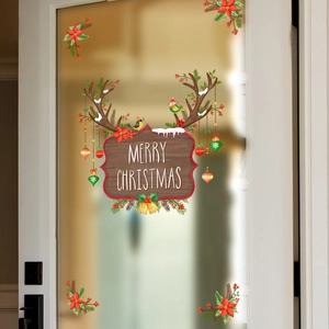 Close-up of Merry Christmas reindeer decal with poinsettia stickers on a glass window