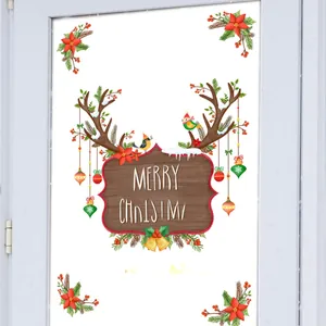 Detail of Merry Christmas reindeer antler decals with red flowers and ornaments on glass