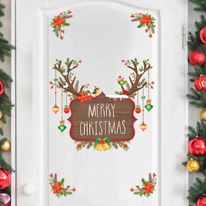 Close-up of Merry Christmas door stickers with reindeer antlers and festive bauble motifs