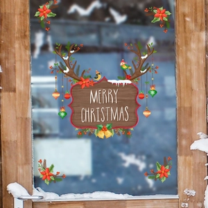 Close-up of Merry Christmas reindeer sign static window stickers with pine and berries decoration