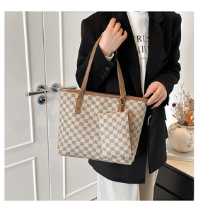 Detail of vintage patterned tote bag with detachable mini pouch and leather handles