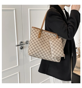 Detail view of checkered tote bag with matching pouch on shoulder for 2025 winter style