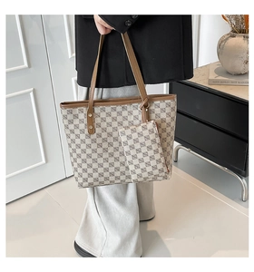 Detail of printed tote bag and matching mini pouch with geometric pattern and brown leather trim