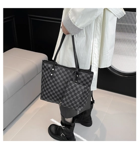 Detail of checkered tote bag with matching pouch showing textured PU leather and rivets